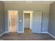 Bedroom with open doors to bathroom and closet and wood-look floors at 4013 Kingcraig Ln, Zebulon, NC 27597