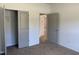 Bedroom featuring carpet and two grey doors, one leading to a closet at 4013 Kingcraig Ln, Zebulon, NC 27597