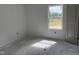 Bedroom with a window overlooking greenery and bare floors at 4013 Kingcraig Ln, Zebulon, NC 27597