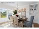 Elegant dining room featuring modern chandelier, stylish decor, and built-in shelving at 4013 Kingcraig Ln, Zebulon, NC 27597
