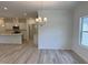 Bright dining room with modern chandelier, large window, and easy access to the open kitchen layout at 4013 Kingcraig Ln, Zebulon, NC 27597