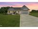 Charming single-Gathering home featuring a well-manicured lawn, long driveway, and attached two-car garage at 4013 Kingcraig Ln, Zebulon, NC 27597