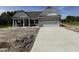 New construction home with a gray exterior, white trim, and a concrete driveway at 4013 Kingcraig Ln, Zebulon, NC 27597