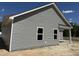 Side view of a new construction home showing gray siding and white trim at 4013 Kingcraig Ln, Zebulon, NC 27597