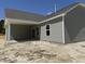 Back of home with covered porch and white pillars providing outdoor living space at 4013 Kingcraig Ln, Zebulon, NC 27597
