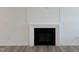 Modern fireplace with a black interior, sleek design, and mounted tv capabilities at 4013 Kingcraig Ln, Zebulon, NC 27597