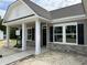 Inviting front entrance with classic columns, detailed stonework, and a well-designed doorway enhancing curb appeal at 4013 Kingcraig Ln, Zebulon, NC 27597