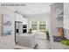 Modern kitchen with white cabinets, stainless appliances, island and adjacent dining area at 4013 Kingcraig Ln, Zebulon, NC 27597