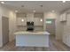 Modern kitchen with white cabinets, quartz countertops, stainless steel appliances, and a spacious center island at 4013 Kingcraig Ln, Zebulon, NC 27597