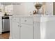 Modern kitchen island with white cabinets and stainless steel appliances for a sleek, functional space at 4013 Kingcraig Ln, Zebulon, NC 27597