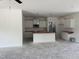 Bright kitchen featuring white cabinets and an island with a sink and stainless steel microwave at 4013 Kingcraig Ln, Zebulon, NC 27597