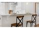 Bright kitchen island with white cabinets, modern faucet and stylish seating, perfect for casual dining at 4013 Kingcraig Ln, Zebulon, NC 27597