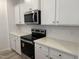 Bright kitchen featuring stainless steel appliances, quartz countertops, white cabinets, and a mosaic tile backsplash at 4013 Kingcraig Ln, Zebulon, NC 27597