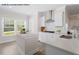 Well-lit kitchen with stainless steel appliances, a central island, and views from the large window at 4013 Kingcraig Ln, Zebulon, NC 27597