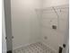 Well-lit laundry room with star patterned floors, utility connections, and wire shelving at 4013 Kingcraig Ln, Zebulon, NC 27597