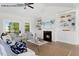 Cozy living room features fireplace, built-in shelving, large windows and neutral furnishings at 4013 Kingcraig Ln, Zebulon, NC 27597