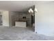 Open-concept space with kitchen view and modern chandelier at 4013 Kingcraig Ln, Zebulon, NC 27597