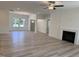 Open concept living area features hardwood floors, fireplace, ceiling fan, and abundant natural light at 4013 Kingcraig Ln, Zebulon, NC 27597