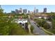 Aerial view of modern townhomes near downtown, surrounded by lush trees and a street with parked cars at 402 Chavis Way, Raleigh, NC 27601