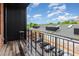 Balcony with dark metal railings and wooden floor offers an urban view of a car park at 402 Chavis Way, Raleigh, NC 27601