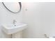Stylish bathroom featuring a sleek sink, modern faucet, and a round mirror against a white wall at 402 Chavis Way, Raleigh, NC 27601