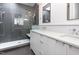 Modern bathroom features a glass shower enclosure and a vanity with double sinks and white countertops at 402 Chavis Way, Raleigh, NC 27601