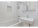 Well-lit bathroom features a clean, white bathtub and shower combination with a pedestal sink at 402 Chavis Way, Raleigh, NC 27601