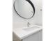 Bathroom vanity features a sleek design with a modern countertop sink, faucet and a dark rimmed mirror at 402 Chavis Way, Raleigh, NC 27601