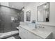 Elegant bathroom featuring dual sinks, a glass shower, and stylish lighting at 402 Chavis Way, Raleigh, NC 27601