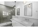 Luxurious bathroom with double sinks, modern fixtures, and glass-enclosed shower at 402 Chavis Way, Raleigh, NC 27601