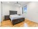 Bright bedroom with hardwood floors, gray finish furniture, and a large window with natural light at 402 Chavis Way, Raleigh, NC 27601