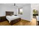Comfortable bedroom with a wooden bed frame, hardwood floors, and plenty of natural light at 402 Chavis Way, Raleigh, NC 27601