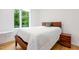 Cozy bedroom with natural light, wooden bed frame, side table, and light wood flooring at 402 Chavis Way, Raleigh, NC 27601
