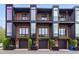 Modern townhome exterior featuring brick facade, balconies, and garage, with contemporary design at 402 Chavis Way, Raleigh, NC 27601