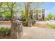 Exterior view of modern townhomes with stone features and lush green trees on a sunny day at 402 Chavis Way, Raleigh, NC 27601