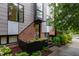 Modern townhouse featuring a brick and gray exterior with large windows and stylish landscaping at 402 Chavis Way, Raleigh, NC 27601