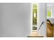 Bright hallway featuring sleek design, natural light from tall windows, and hardwood floors at 402 Chavis Way, Raleigh, NC 27601