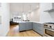 Modern kitchen featuring stainless steel appliances and open living room concept at 402 Chavis Way, Raleigh, NC 27601