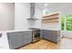 Bright kitchen featuring white countertops, grey cabinets, and stainless steel appliances at 402 Chavis Way, Raleigh, NC 27601