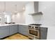 Modern kitchen with white countertops, hexagon tile backsplash, and stainless steel appliances at 402 Chavis Way, Raleigh, NC 27601