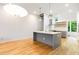 Modern kitchen with white countertops, grey cabinets, and hardwood floors at 402 Chavis Way, Raleigh, NC 27601