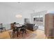 Bright living room with hardwood floors, a comfortable sofa, and a window overlooking the neighborhood at 402 Chavis Way, Raleigh, NC 27601