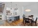 Open living space with kitchen island, dining area, and wood floors creating an inviting atmosphere at 402 Chavis Way, Raleigh, NC 27601