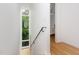 Bright stairwell with light hardwood floors and a contemporary steel handrail at 402 Chavis Way, Raleigh, NC 27601