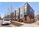 Modern townhomes boast a contemporary design with brick and metal exteriors and large, prominent windows at 402 Chavis Way, Raleigh, NC 27601