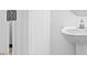 Well-lit half bathroom features a pedestal sink and a white door at 41 Alderman Ct # 2, Dunn, NC 28334