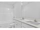 Bright bathroom featuring double sinks with quartz countertops and white cabinets below at 41 Alderman Ct # 2, Dunn, NC 28334