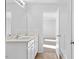 A bathroom with double sinks, quartz countertop, white cabinets and view to the bedroom at 41 Alderman Ct # 2, Dunn, NC 28334
