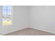 Well-lit bedroom with neutral carpet features a window providing natural light at 41 Alderman Ct # 2, Dunn, NC 28334