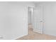 A neutral bedroom features an open door leading to another room with beige carpeting at 41 Alderman Ct # 2, Dunn, NC 28334